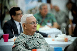 Photo of Maj. Gen. Raymond Peters listening to Maj. Gen. John Nichols.